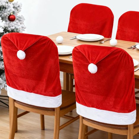 Set Mit 4 Roten Stuhlrückenschonern Mit Weihnachtsmotiven Und Niedlichen Weihnachtsmannmützen Für Die Weihnachtsdekoration In Haus, Küche Und Esszimmer.