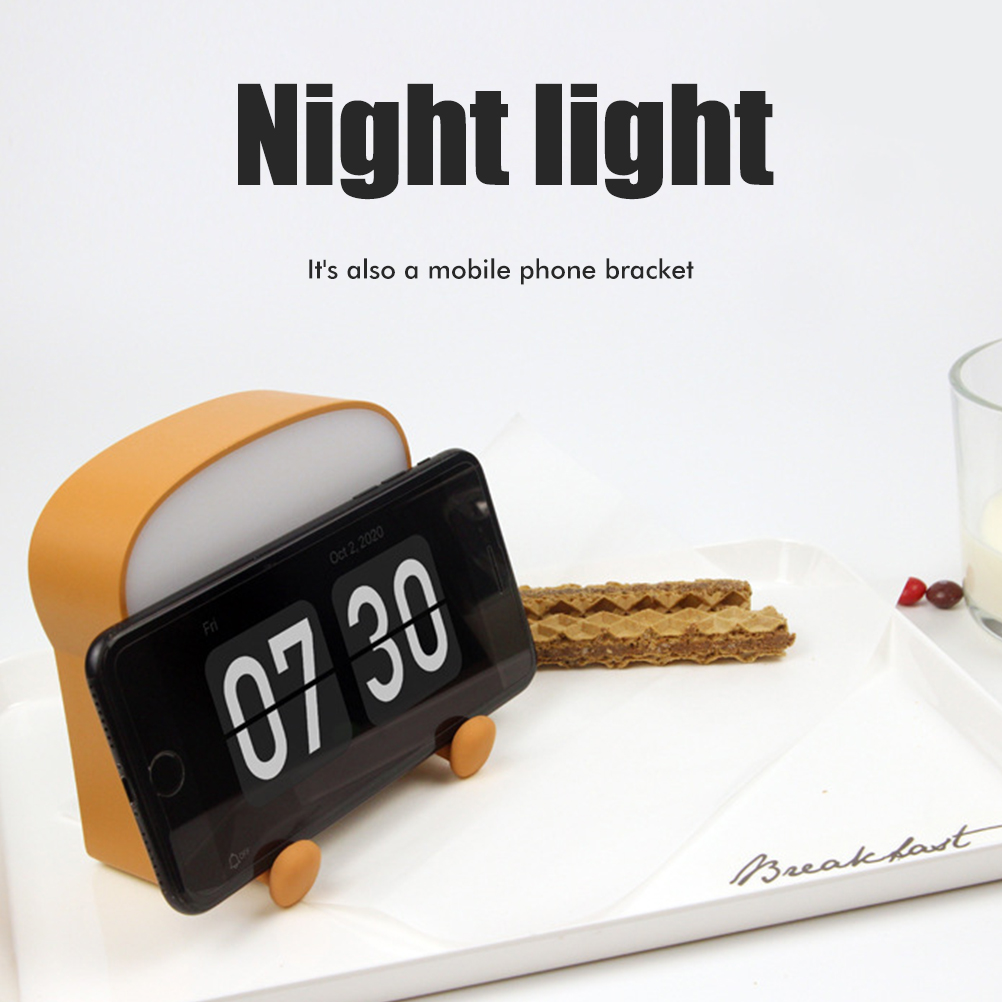 Wiederaufladbares Und Tragbares Led-nachtlicht In Form Eines Toasts Mit Handyhalterung Aus Silikon.